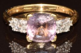 An 18k gold ring set with a cushion cut pink tanzanite of approximately 2.2ct, ten round cut