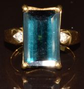 An 18k gold ring set with an emerald cut Mutuca indicolite of approximately 7.4ct and diamonds, with
