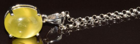 A 9k white gold pendant set with a yellow cabochon, on 9k white gold chain, 3.9g, 44cm