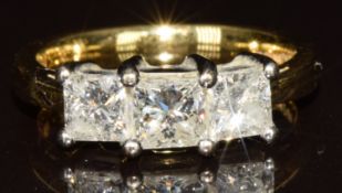 An 18ct gold ring set with three princess cut diamonds, totalling approximately 1.5ct, 5.1g, size L