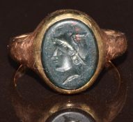 A 9ct gold ring set with a bloodstone intaglio of Hermes, 2.5g, size G