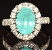 A 14k white gold ring set with an oval cut Paraiba tourmaline of approximately 3.5ct surrounded by