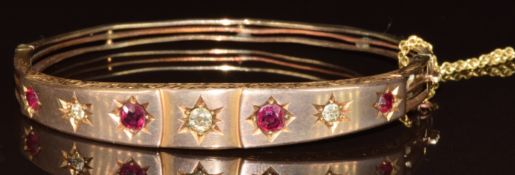 Edwardian 9ct gold bangle set with four rubies and diamonds in star settings, 10.1g