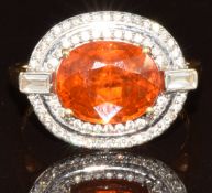 An 18k gold ring set with an oval cut Mandarin garnet of approximately 5ct, surrounded by two