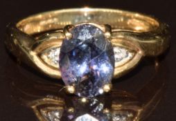 A 9k gold ring set with an oval cut Chameleon tanzanite of approximately 1.9ct and diamonds, 3g,