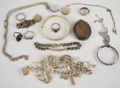 A collection of silver jewellery including charm bracelet, sweetheart brooch with applied gold