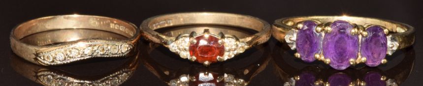 Three 9ct gold rings, one set with amethysts and diamonds, one with diamonds and the other garnet