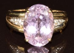 A 9k gold ring set with an oval cut AAA Brazilian kunzite of approximately 7.1ct and white
