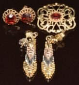 A 9ct gold brooch and a pair of 9ct gold earrings set with garnets (3.7g) and a pair of silver