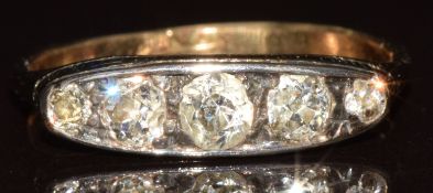 A 9ct gold ring set with five old cut diamonds, the centre diamond approximately 0.15ct, in a silver