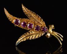 A 9ct gold brooch in the form of three fern leaves set with five garnets, 4.3g, 4cm