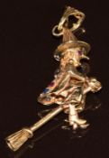 A 9ct gold pendant in the form of a witch on a broomstick set with synthetic gemstones, the witch'