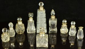 Ten hallmarked silver and cut glass scent / perfume bottles, tallest 17cm