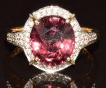 An 18k gold ring set with an oval cut Bekily colour change garnet of approximately 5.5ct