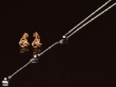 An 18ct white gold necklace set with three diamonds in square settings (2.4g, 38cm) and a pair of