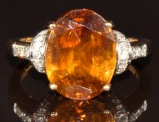 An 18ct gold ring set with an oval cut quartz and diamonds, 5.7g, size N/O