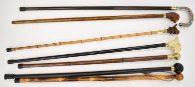 Seven novelty walking sticks including one with billiard ball finial, carved seal, birds etc,