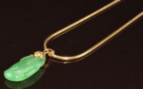 An 18ct gold snake chain (10g, 45cm) with carved jadeite pendant with yellow metal pendant loop, 2.