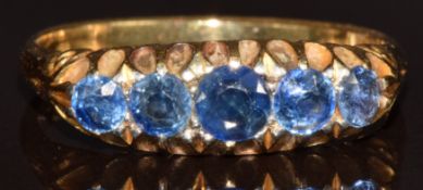 A c1900 18ct gold ring set with five round cut sapphires, the centre sapphire approximately 0.