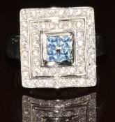 An 18ct white gold ring set with cubic zirconia in a rectangular setting, 10.8g, size P