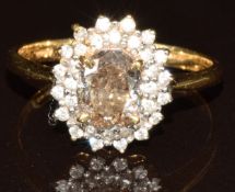 An 18k gold ring set with an oval brilliant cut Argyle champagne diamond of approximately 1.2ct