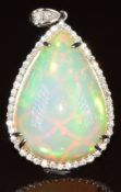 A platinum pendant set with a pear cut Ethiopian welo opal of approximately 19.7ct surrounded by