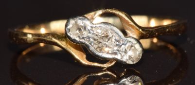 An 18ct gold ring set with three diamonds, 1.4g, size L