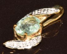 A 9k gold pendant set with an oval cut Paraiba tourmaline of approximately 0.65ct and diamonds, with