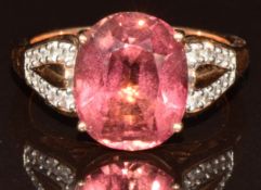 An 18k rose gold ring set with an oval cut lotus tourmaline of approximately 5.3ct and twenty