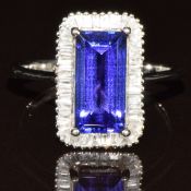 A platinum ring set with a baguette cut AAA tanzanite of approximately 3ct surrounded by baguette