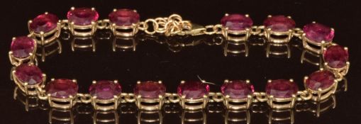 A 9k gold bracelet set with sixteen oval cut Malawi garnets, total 26ct, with certificate, 12.4g,