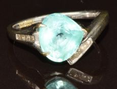 An 18k white gold ring set with a pear cut Paraiba tourmaline of approximately 3.1ct and eight