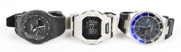 Three Casio G-Shock gentleman's wristwatches ref. GMA-2100, GA-2100 and GBD-200, all on rubber
