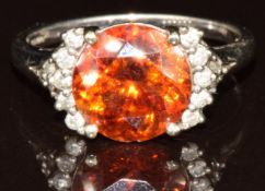 A 9k white gold ring set with a round cut sphalerite and round cut diamonds, with certificate, 3.3g,