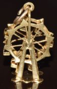 An 18k gold charm in the form of a Ferris wheel, 2.1g