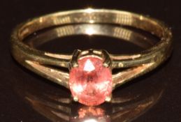 A 9k gold ring set with an oval cut Padparadscha sapphire of approximately 0.7ct, with