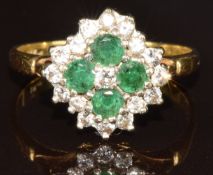 An 18ct gold ring set with four round cut emeralds and diamonds, 5.3g, size Q