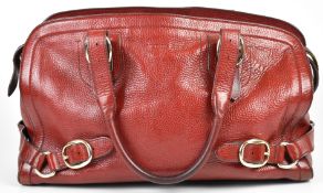 Burberry satchel in burgundy grained leather with gold tone Burberry branded hardware, signature