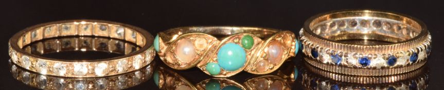 Two 9ct gold eternity rings set with synthetic stones (4g, size K & P) and a yellow metal ring set