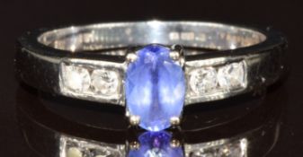 An 18k white gold ring set with an oval cut tanzanite of approximately 0.5ct and four round cut