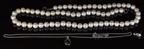 A 9ct white gold pendant set with a diamond, on 9ct white gold chain (2.8g), a single earring and