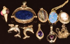 Eight 9ct gold pendants including locket, amethyst, cameo, enamel set ice cream, two dolphins,