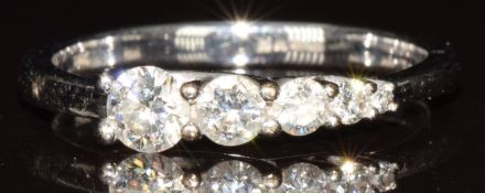 An 18k white gold ring set with five graduating diamonds, the largest diamond approximately 0.2ct,