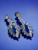 A pair of 18ct white gold earrings, each set with a marquise cut sapphire of approximately 1ct