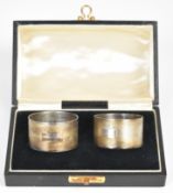 Cased pair of George VI hallmarked silver napkin rings with engine turned decoration, Birmingham