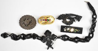 A collection of Victorian jewellery including two Whitby jet brooches, one carved in the form of a