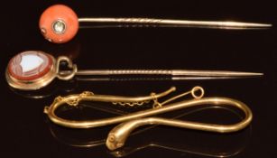 Victorian stick pin set with coral inset with a rose cut diamond, a Victorian stick pin set with a
