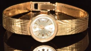 Walker 18ct gold ladies wristwatch with gold hands and hour markers, silver dial and 17 jewel