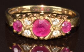 A 9ct gold ring set with three round cut rubies and diamonds, 3.1g, size O