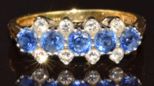 An 18ct gold ring set with five round cut sapphires and eight diamonds, 3.1g, size J